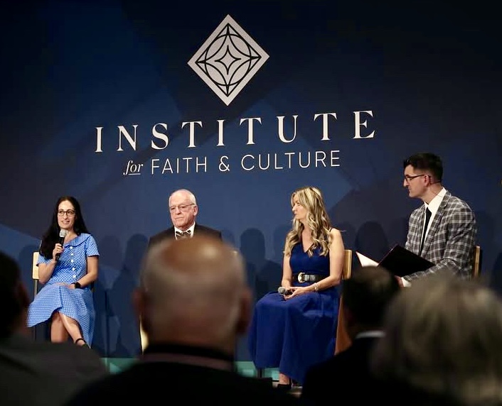 Pamela Garfield-Jaeger speaking into a microphone on a panel at the Institute for Faith & Culture