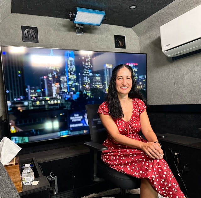 Pamela Garfield-Jaeger seated in a television studio before an interview