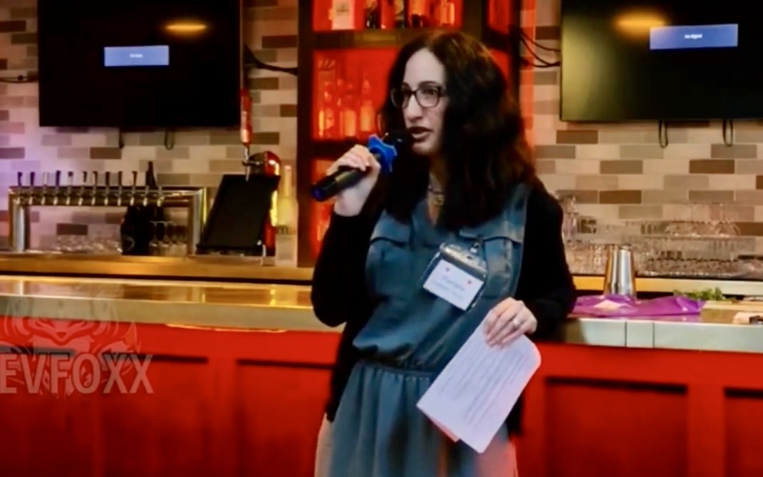 Pamela Garfield-Jaeger speaking into a microphone at a live event